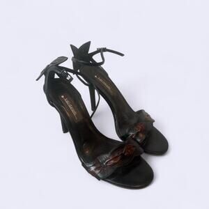 Kaki Daniels black leather heels with a flower bow detail